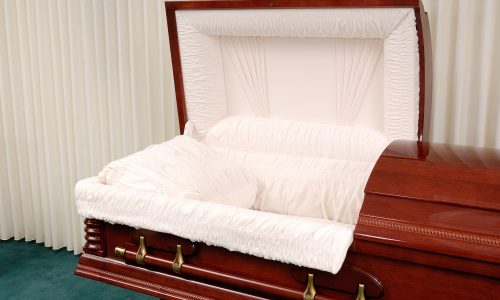 Wooden casket made of Cherry in a funeral home.